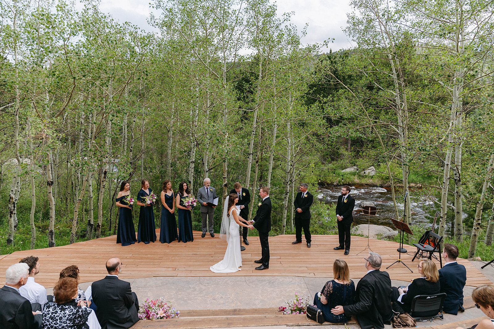 Jason and Amy kissing on the rocks framed by aspen trees